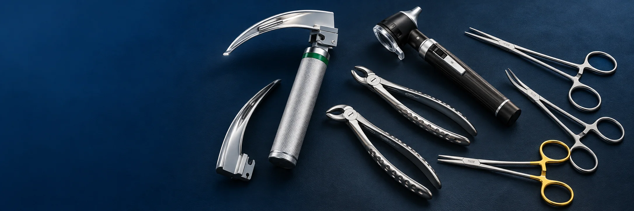 A fiber optic laryngoscope, mini otoscope, dental extraction forceps and surgical instruments arranged on navy.
