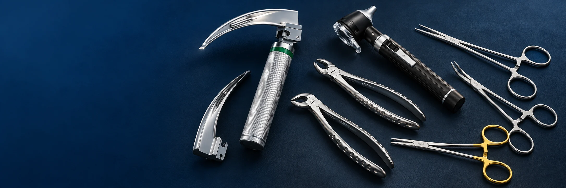 A fiber optic laryngoscope, mini otoscope, dental extraction forceps and surgical instruments arranged on navy.
